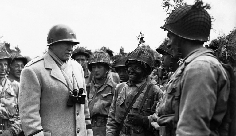 Shortly before D-Day, Gen. George Patton (pictured left) fully expected that brutal combat waited just over the horizon. And so, just before landing time, Patton addressed his soldiers and told them to prepare to annihilate the enemy. (AP Photo)