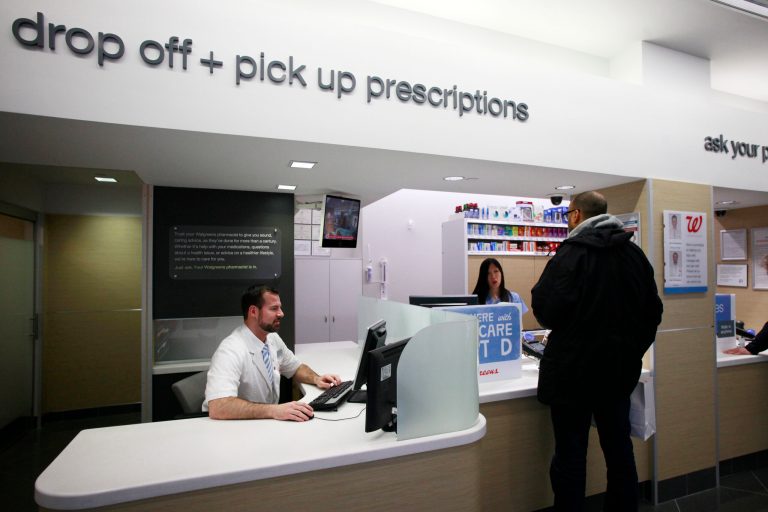 FILE - In this Wednesday, May 15, 2013, file photo, a pharmacist works at his desk located next to the prescription pick up counter in New York. New details from two studies reveal more side effects from niacin, a drug that hundreds of thousands of Americans take for cholesterol problems and general heart health.  (AP Photo/Mark Lennihan, File)