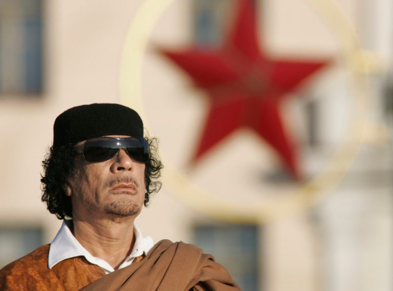 FILE - In this Monday, Nov. 3, 2008 file photo, Libyan leader Moammar Gadhafi attends a wreath laying ceremony in the Belarus capital Minsk. Gadhafi of nearly 42 years was captured by rebel forces in his hometown of Sirte in Oct. 2011. Libyan officials initially said Gadhafi was killed in crossfire between rebel fighters and loyalists. However, video footage emerged showing him being beaten, taunted and abused by his captors, raising questions about how and when he died. (AP Photo/Sergei Grits, File)