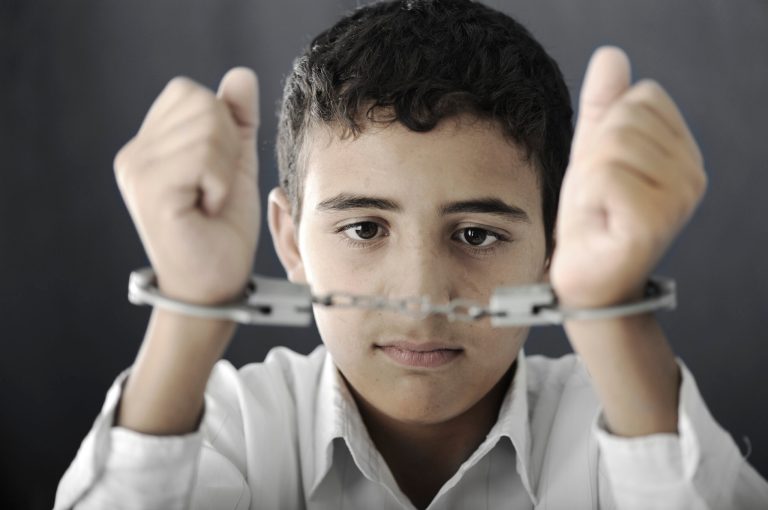 Even the youngest defendants are brought to court weighed down by chains. Girls, who comprise about a third of the juvenile justice system nationally, are shackled the same as boys. In some places, the children are shackled to each other so that if one trips the others fall like tenpins. (iStock Photo)