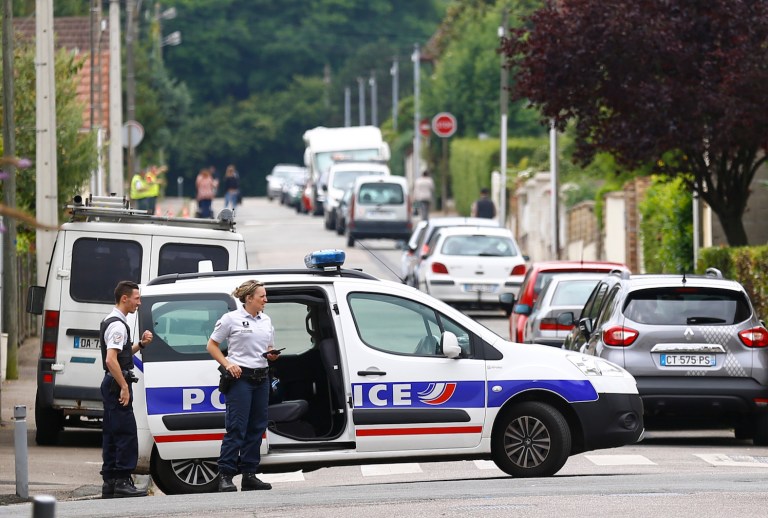 Two attackers invaded a church Tuesday during morning Mass near the Normandy city of Rouen, killing an 84-year-old priest by slitting his throat and taking hostages before being shot and killed by police, French officials said. (AP Photo/Francois Mori)
