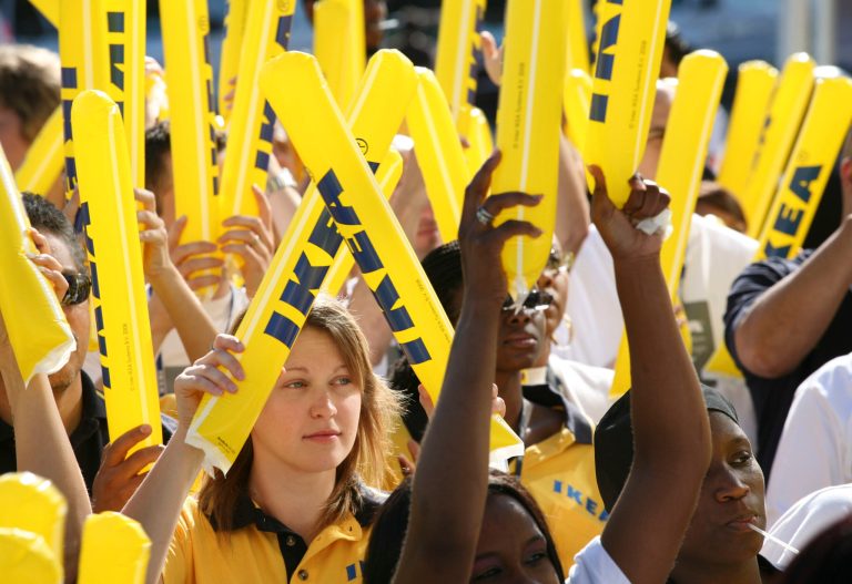 FILE - In this June 18, 2008 file photo, Ikea employees cheer during the grand opening of New York City's first Ikea store, in Brooklyn. Ikea on Thursday, June 26, 2014 plans to announce its U.S. division is raising the minimum wage for thousands of its retail workers, pegging it to the cost of living in each location, instead of its competition. (AP Photo/Mark Lennihan, File)