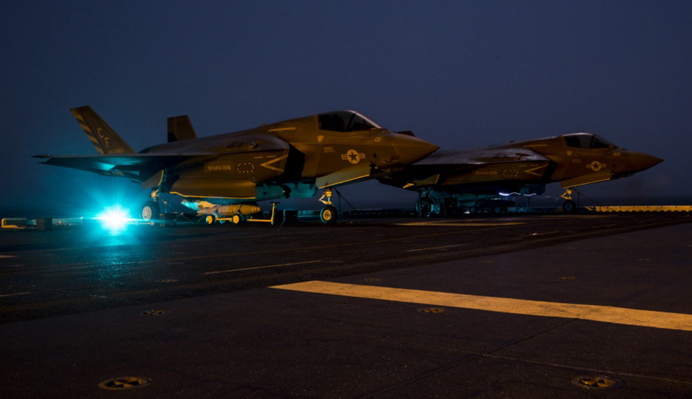U.S. Marines with Marine Fighter Attack Squadron 211, 13th Marine Expeditionary Unit, stage ordnance before loading it into an F-35B Lightning II aboard the Wasp-class amphibious assault ship USS Essex in preparation for the F-35B's first combat strike on Thursday.