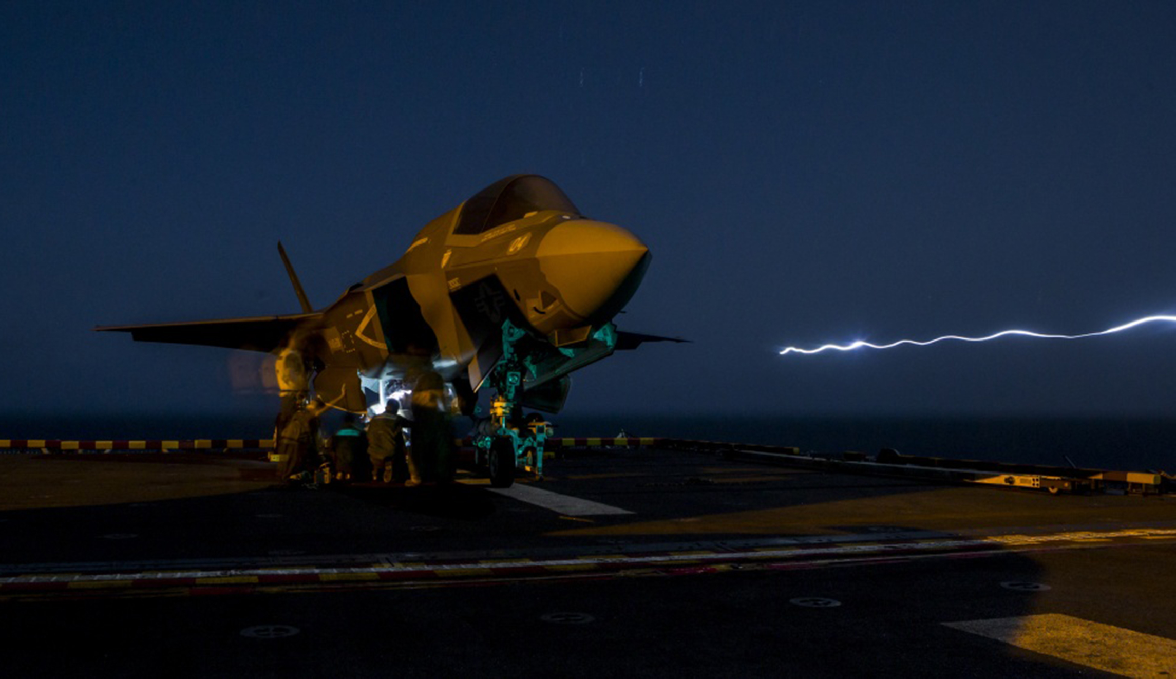 U.S. Marines with Marine Fighter Attack Squadron 211, 13th Marine Expeditionary Unit, load ordnance into an F-35B Lightning II aboard the Wasp-class amphibious assault ship USS Essex in preparation for the F-35B's first combat strike on Thursday.
