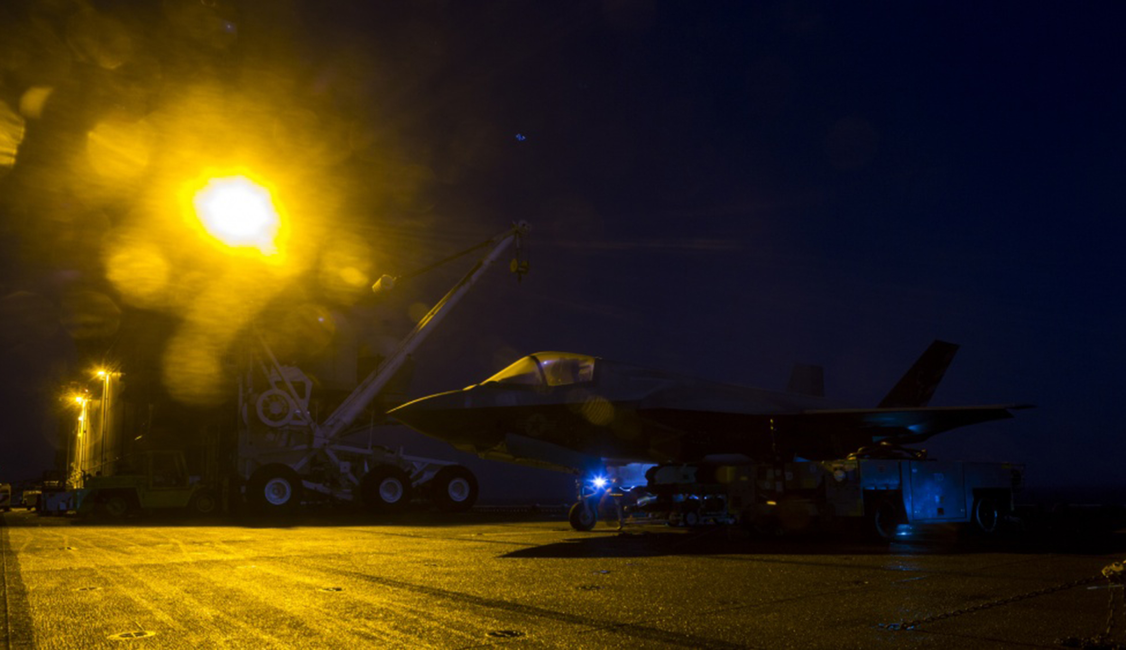 U.S. Marines with Marine Fighter Attack Squadron 211, 13th Marine Expeditionary Unit , load ordnance into an F-35B Lightning II aboard the Wasp-class amphibious assault ship USS Essex in preparation for the F-35B's first combat strike on Thursday.