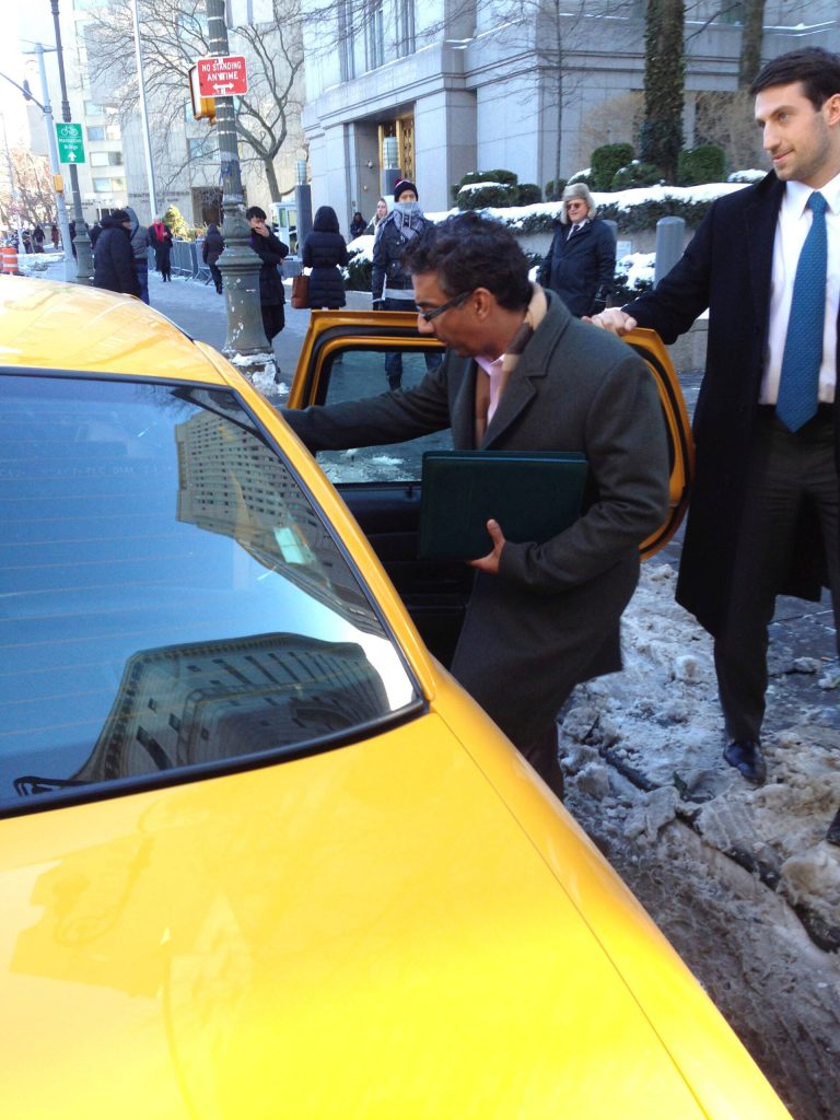 Conservative scholar Dinesh D'Souza, left, gets into a taxicab after pleading not guilty to charges that he violated campaign finance laws, in federal court, Jan. 14, in New York. He was released on $500,000 bond and his travel was restricted to the United States. (AP Photo/Larry Neumeister)