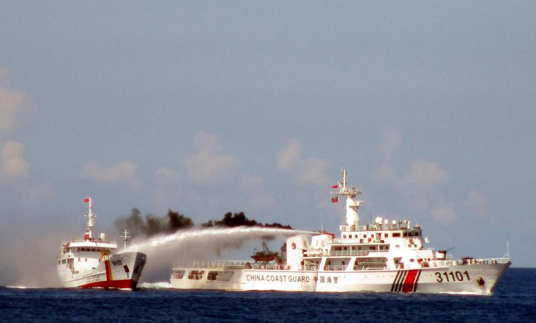 In this Sunday, May 4, 2014 Image made from video released by Vietnam Coast Guard, a Chinese coast guard vessel, right, fires a water cannon at a Vietnamese vessel off the coast of Vietnam. (AP Photo/Vietnam Coast Guard)