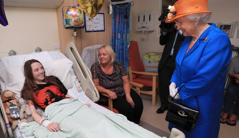Britain's Queen Elizabeth II speaks to Millie Robson, 15, and her mother, Marie, as she visits the Royal Manchester Children's Hospital in Manchester, England, to meet victims of the terror attack in the city earlier this week and to thank members of staff who treated them Thursday May 25, 2017. (Peter Byrne/Pool via AP)