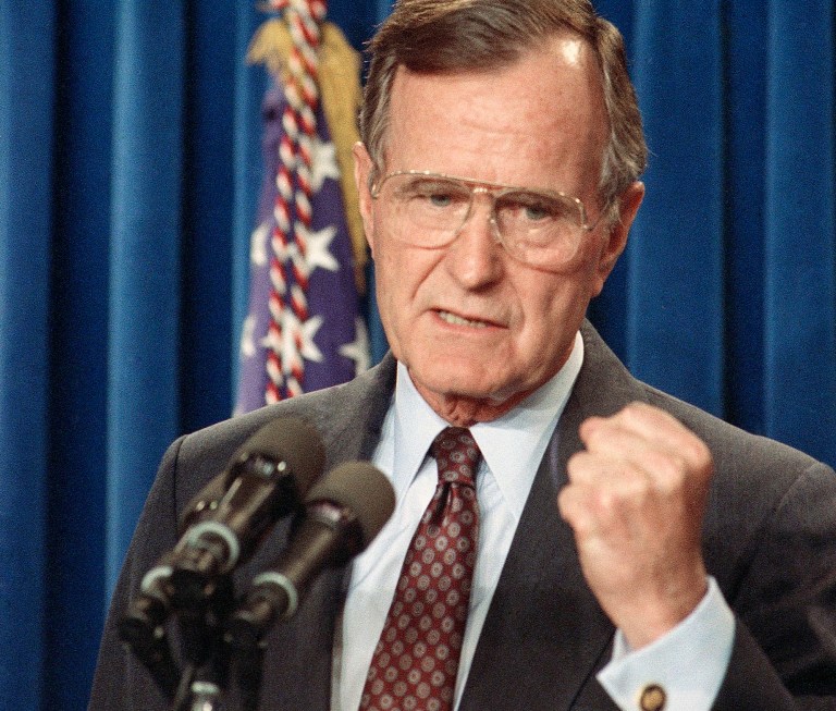 President George H.W. Bush gestures during a news conference at the White House briefing room in Washington, Tuesday, April 17, 1991. (AP Photo/Marcy Nighswander)