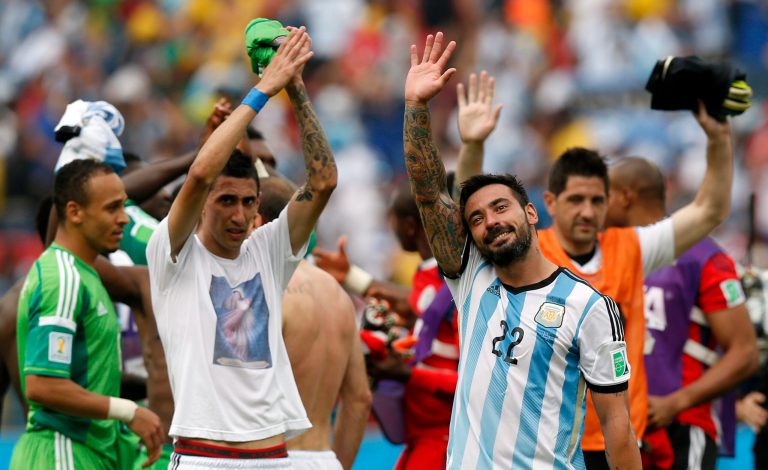 Argentina's Angel di Maria, left, and Ezequiel Lavezzi wave to spectators after their 3-2 win over Nigeria in the group F World Cup soccer match between Nigeria and Argentina at the Estadio Beira-Rio in Porto Alegre, Brazil, Wednesday, June 25, 2014. (AP Photo/Victor R. Caivano)