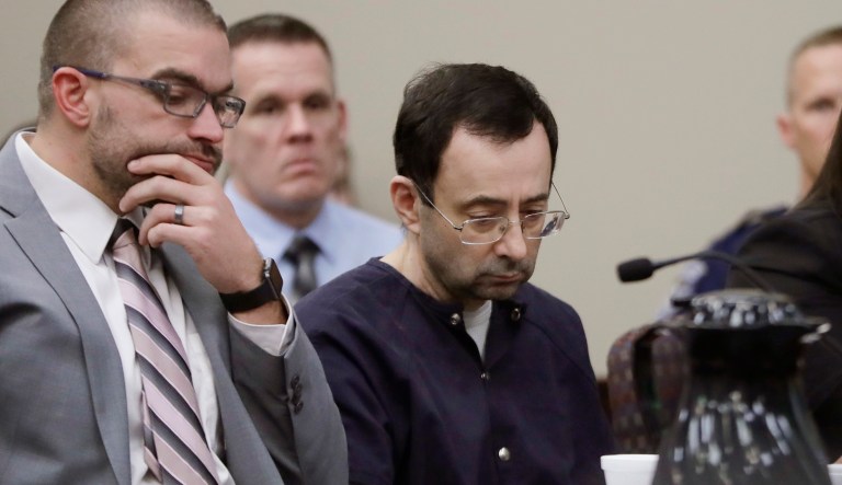 In the wake of a sexual abuse scandal involving sports doctor Larry Nassar (pictured center-right), the U.S. Olympic Committee is demanding that the rest of the USA Gymnastics board resign. A judge sentenced Nassar to up to 175 years in prison for multiple sex crimes. (AP Photo/Carlos Osorio)
