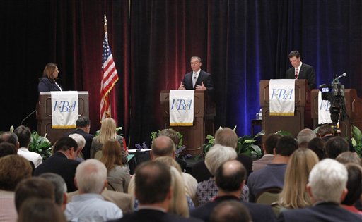 Former Virginia Gov. Timothy M. Kaine, center, gestures as former U.S. Sen. George Allen, right, and moderator Candy Crowley, left, listen during Saturday's debate. Defense cuts have become a major issue in the campaign. (AP photo)