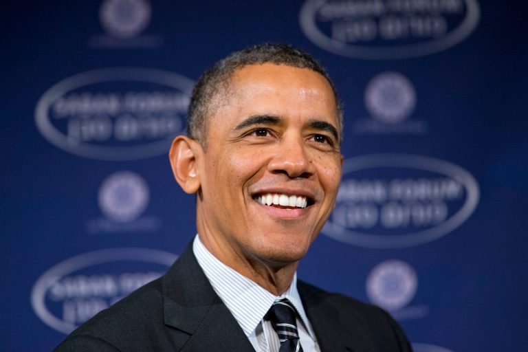 President Barack Obama smiles as he arrives at the Saban Forum to speak about the Middle East at the Willard Hotel in Washington, Saturday, Dec. 7, 2013. The 2013 Forum is examining the political changes taking place across the Middle East, and the President spoke about topics including Iran. (AP Photo/Jacquelyn Martin)