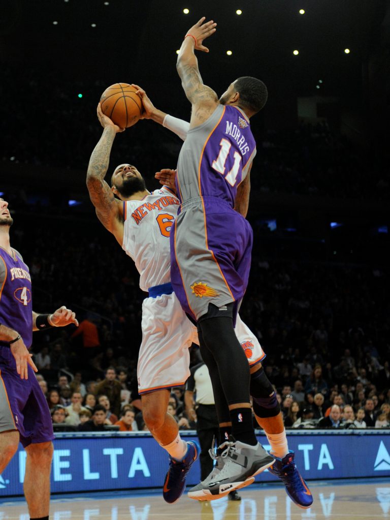   New York Knicks' Tyson Chandler, left, is fouled by Phoenix Suns' Markieff Morris in the first quarter of an NBA basketball game at Madison Square Garden in New York, Sunday, Dec. 2, 2012. (AP Photo/Henny Ray Abrams)  