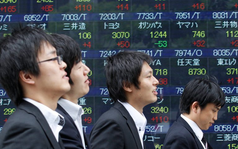   People walk by an electronic stock board of a securities firm in Tokyo, Monday, June 11, 2012 as Japan's Nikkei 225 index jumped 165.64 points and closed at 8,624.90. Asian stocks and the euro climbed Monday after Spain sought a lifeline for its ailing banks, easing fears that Europe's debt crisis was about to spin out of control. (AP Photo/Koji Sasahara)  