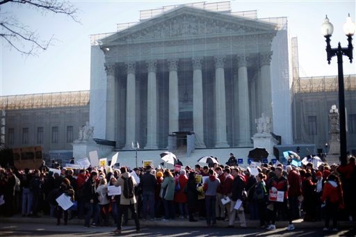 Demonstrators stand outside the Supreme Court on Tuesday, when the court heard arguments on Californiaâs voter approved ban on same-sex marriage, Proposition 8. (AP Photo/Pablo Martinez Monsivais)