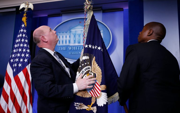 The presidential flag is readied in the James Brady Press Briefing Room of the White House in Washington, Friday, Aug. 1, 2014, after it was announced that President Barack Obama will deliver a statement. (AP Photo/Charles Dharapak)