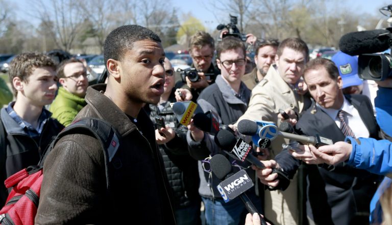 Former Northwestern University football player Michael Odom talks to reporters as his former teammates vote on the student athlete union question Friday, April 25, 2014, in Evanston, Ill. (AP Photo/Charles Rex Arbogast)