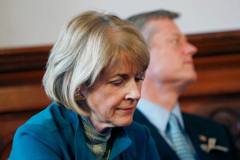 Massachusetts gubernatorial candidates, Democrat Martha Coakley, foreground, and Republican Charlie Baker, behind, sit together while participating in the Greater Boston Interfaith Candidates Forum at Fourth Presbyterian Church in Boston. (AP Photo/Michael Dwyer)