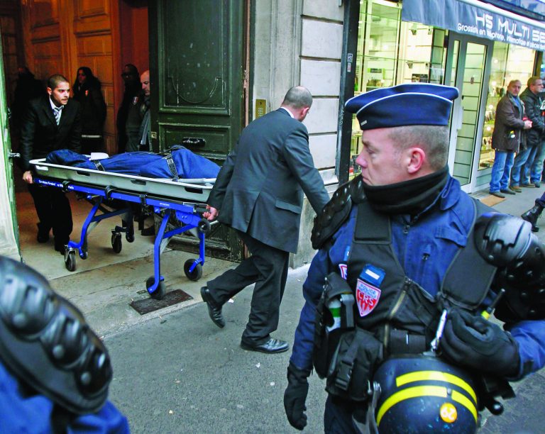 One of the three bodies of the killed Kurdish women is taken out of the building in Paris, Thursday Jan. 10, 2013. Police say three Kurdish women have been shot dead at a pro-Kurdish centre in Paris in what the French interior minister is calling an 'execution'. (AP Photo/Remy de la Mauviniere)