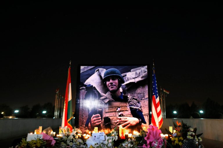 A photograph of James Foley, the freelance journalist killed by ISIS, is seen during a memorial service in Irbil, Iraq, on Sunday. (AP/ Marko Drobnjakovic)