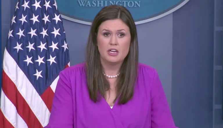 White House deputy press secretary Sarah Sanders told the reporters in the room to watch the undercover video. (Screenshot)