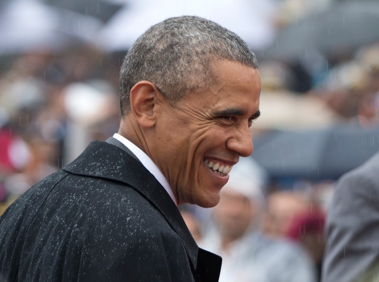 U.S. President Barack Obama smiles in the rain as he arrives for Republic Day in New Delhi, India. (AP/Carolyn Kaster)