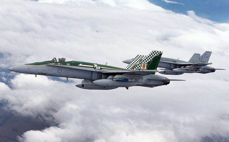 Two Royal Australian Air Force F/A-18 Hornets participate in a midair refueling exercise on February 27, 2013 in Melbourne. (Photo by Michael Dodge/Getty Images)
