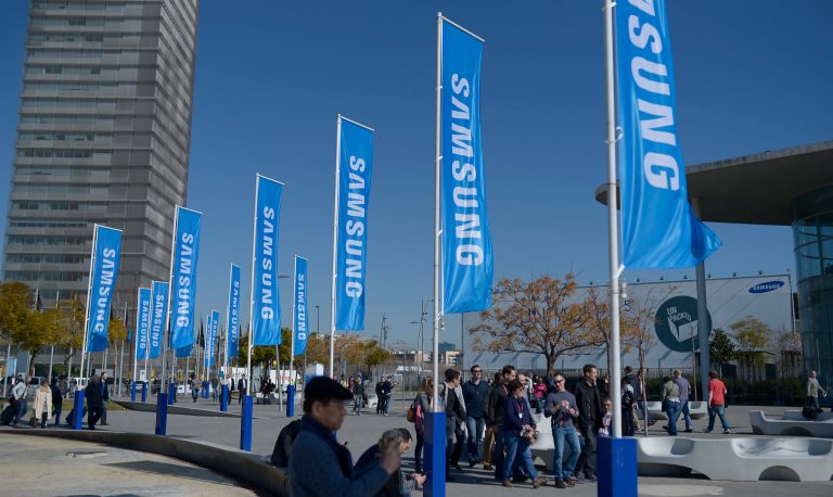 Visitors walk outside  the Mobile World Congress, the world's largest mobile phone trade show, in Barcelona, Spain, Sunday, Feb. 23, 2014. (AP Photo/Manu Fernandez)