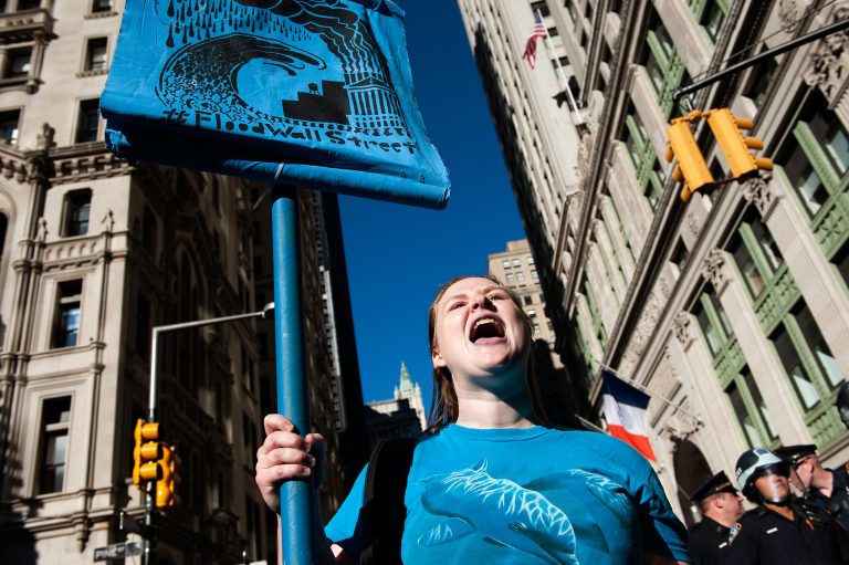 A woman demonstrates in the middle of Broadway during the Flood Wall Street protest. (Getty images/Bryan Thomas)