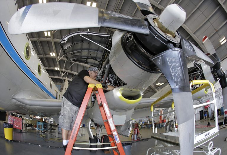 Technician Joseph Klippel works on the engines on the National Oceanic and Atmospheric Administration's P-3 turboprop aircraft 