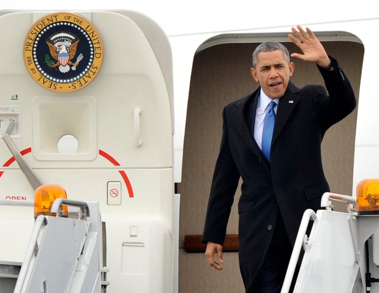 President Barack Obama waves as he steps off Air Force One after landing at O'Hare International Airport in Chicago, Wednesday, April 2, 2014, to attend fundraising events. (AP Photo/Paul Beaty)