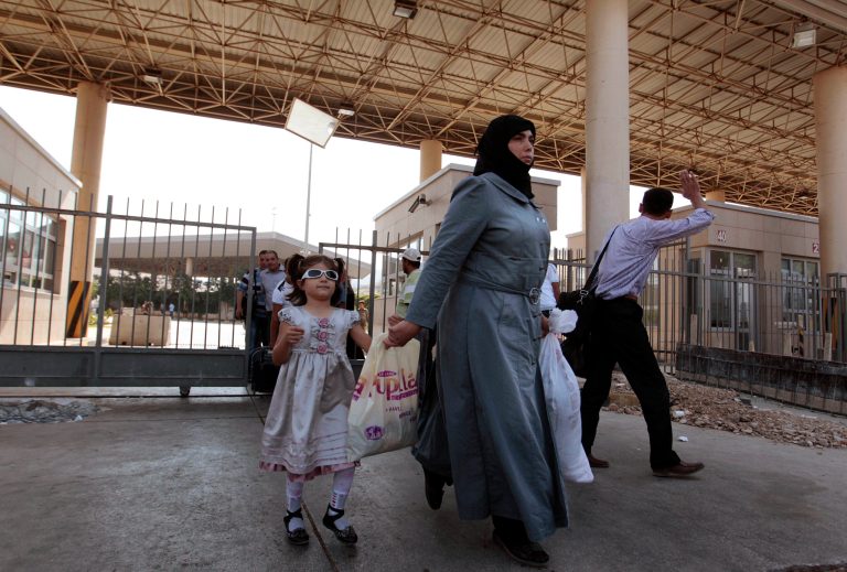   Syrian refugees pass through the Turkish Cilvegozu gate border with Syria, Friday, Aug. 30, 2013. United Nations experts are investigating the alleged use of chemical weapons in Syria as the United States and allies prepare for the possibility of a punitive strike against President Bashar Assad's regime, blamed by the Syrian opposition for the attack. The international aid group Doctors Without Borders says at least 355 people were killed in the Aug. 21 attack. (AP Photo/Gregorio Borgia)  