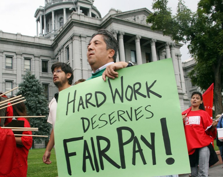 With about 60 percent of the vote reported, voters by a margin of 55 percent to 45 percent backed a constitutional amendment to raise the minimum to $12 an hour from $8.31. (AP Photo/David Zalubowski)