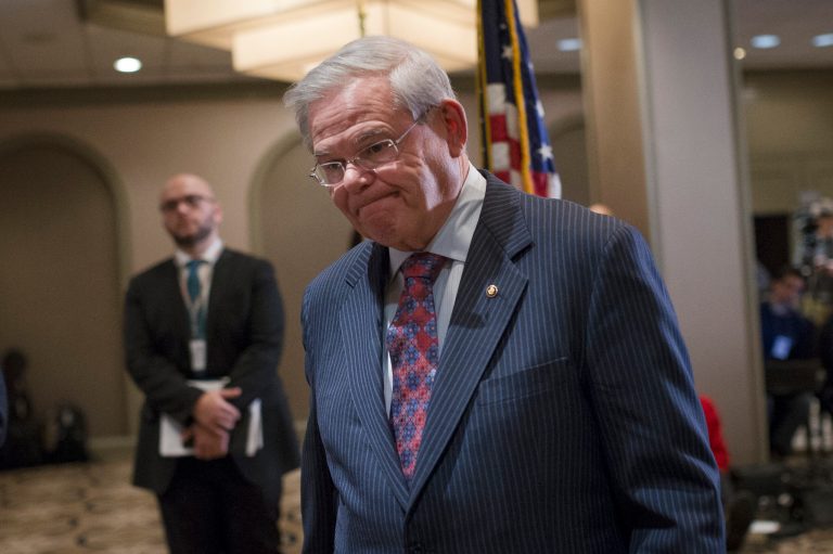Sen. Bob Menendez, D-N.J., leaves after a news conference in Newark, N.J. on Friday, March 6, 2015. A person familiar with a federal investigation says the Justice Department is expected to bring criminal charges against the New Jersey Democrat in the coming weeks. Menendez says that he has always behaved appropriately in office. (AP Photo/John Minchillo)