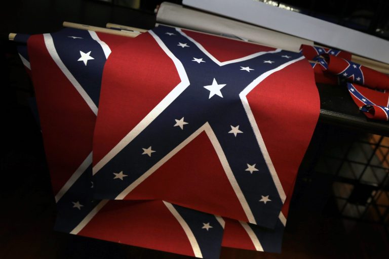 Small Confederate flags are displayed on a shelf at Arkansas Flag and Banner in Little Rock, Ark., Tuesday, June 23, 2015. (AP Photo/Danny Johnston)
