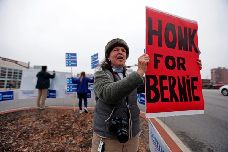 Tara Orlando of Floyd, Va., a supporter of Democratic presidential candidate Sen. Bernie Sanders, I-Vt., cheers for passing motorists to honk outside the University of South Carolina School of Law. (AP Photo/Gerald Herbert)