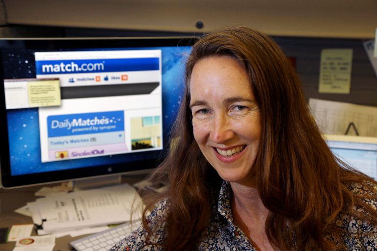   Lynn Boyden, an information architect in web services at the University of Southern California, poses with a dating website on her computer at the USC information technology services center in Los Angeles Wednesday, Sept. 4, 2013. Boyden says she has developed two identities online: a public one for her professional life and a private one that only a few close friends can access. She tries to block advertising trackers when she can and limits what personal data might wind up on public sites. (AP Photo/Reed Saxon)  