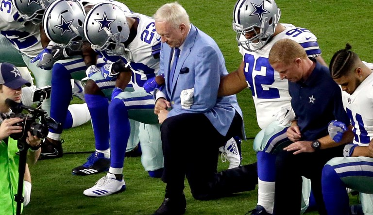 The Dallas Cowboys, led by owner Jerry Jones,, take a knee prior to the national anthem before an NFL football game against the Arizona Cardinals in Glendale, Ariz. (AP Photo/Matt York, File)