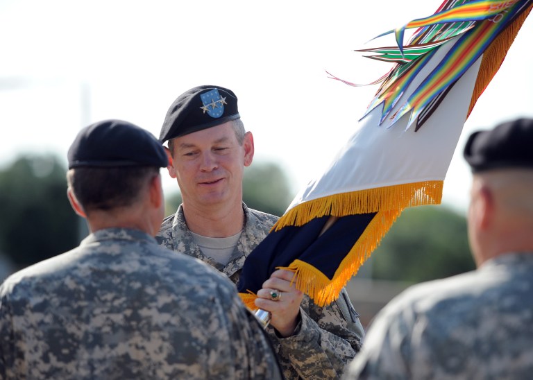 In this image provided by Fort Hood Public Affairs, Lt. Gen. Sean B. MacFarland, commanding general of III Corps and Fort Hood, receives the III Corps colors from Gen. Daniel B. Allyn, commanding general of the U.S. Army Forces Command, during the III Corps change of command ceremony on Aug. 8, 2014 at Fort Hood, Texas. (U.S. Army photo by Daniel Cernero, III Corps and Fort Hood Public Affairs)