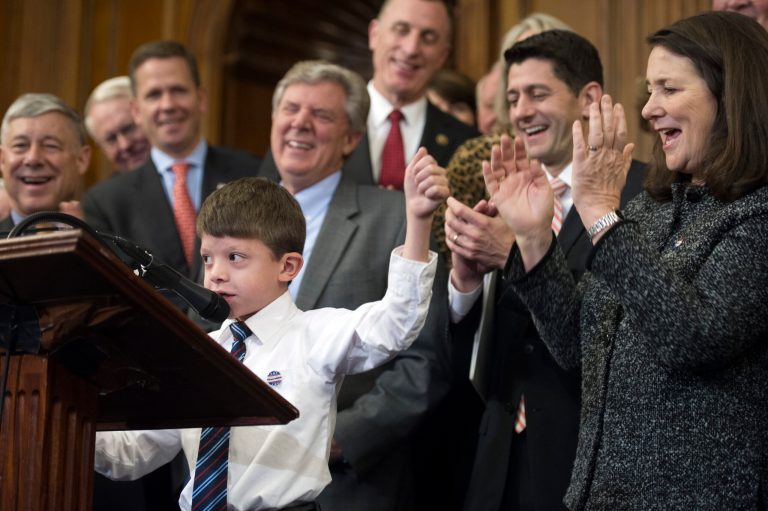 Rep. Fred Upton, R-Mich., left, House Speaker Paul Ryan, of Wis., and Rep. Diana DeGette, D- Co., right, join other members of Congress as they applaud Max Schill, 7, while he speaks on Capitol Hill in Washington, Thursday, Dec. 8, 2016, during the signing ceremony for the 21st Century Cures Act. Schill suffers from Noonan Syndrome. (AP Photo/Cliff Owen)