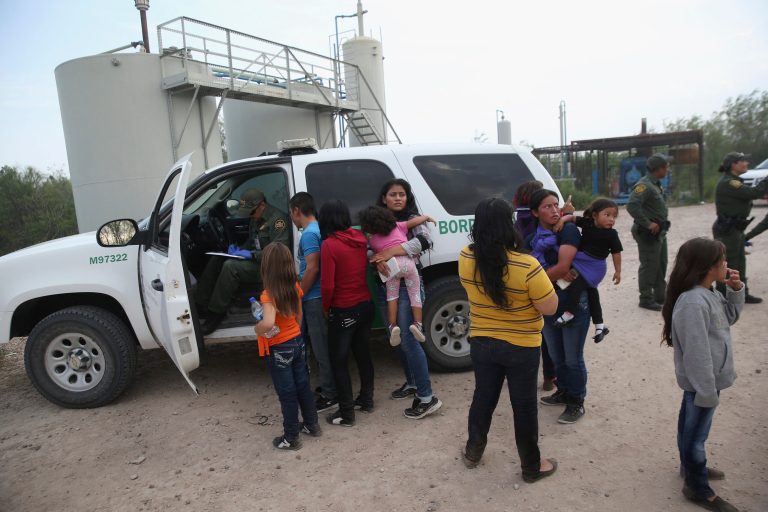 Central American immigrants answer questions from a U.S. Border Patrol agent after crossing the Rio Grande from Mexico into the United States on July 24, 2014 near Mission, Texas. (Photo by John Moore/Getty Images)