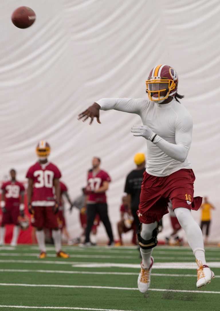 Washington Redskins' quarterback Robert Griffin III throws during a NFL football minicamp at Redskins Park, Tuesday, June 11, in Ashburn, Va. (AP Photo/Carolyn Kaster)