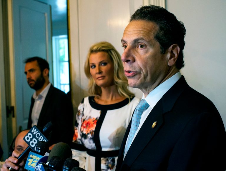FILE - In this Sept. 9, 2014 file photo, Governor Andrew Cuomo, stands with his partner Sandra Lee, center, while addressing members of the media after casting a vote in the primary election at the Presbyterian Church of Mount Kisco in Mount Kisco, N.Y.  The voters who delivered a stinging rebuke to Cuomo in Tusday's Democratic primary were an unusual coalition: critics of hydraulic fracturing, rural voters concerned about the economy people who wanted to elect Zephyr Teachout as the state's first female governor. The question for Cuomo now is can he win them back as he pivots toward his November matchup with Republican Rob Astorino? (AP Photo/Craig Ruttle)