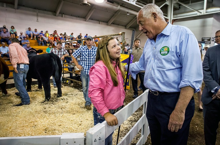 Illinois Gov. Pat Quinn congratulates Shaelye Varner, center, on her Grand Champion Steer during the Governor's Sale of Champions at the Illinois State Fair, Tuesday, Aug. 12, 2014, in Springfield, Ill. A record $100,000-plus was bid for Varner's steer, which is named Ted because she thinks he is like a teddy bear. (AP Photo/The State Journal-Register, Justin L. Fowler)