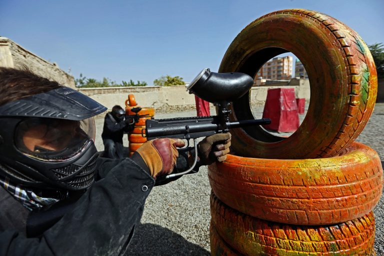 In this Friday, Aug. 22, 2014 photo, a man aims his gas-powered gun at his opponents as he plays in a friendly game of paintball in Kabul, Afghanistan. The arrival of recreational paintball to Afghanistan may seem peculiar to outsiders, especially in a country that's known decades of war, faces constant bombings and attacks by Taliban insurgents and is preparing its own security forces for the withdrawal of most foreign troops by the end of the year. However, it shows both the rise of a nascent upper and middle class looking for a diversion with the time to spare, as well as the way American culture has seeped into the country since the 2001 U.S.-led invasion to topple the Taliban. (AP Photo/Rahmat Gul)