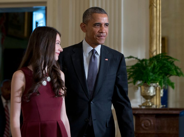 President Obama and Elana Simon, 19, a student at Harvard University who met with the president at last year's White House Science Fair, arrive in East Room in the White House in Washington, Friday, Jan. 30, 2015, where the president spoke about the move away from one-size-fits-all-medicine, toward an approach that tailors treatment to your genes. (AP Photo/Carolyn Kaster)