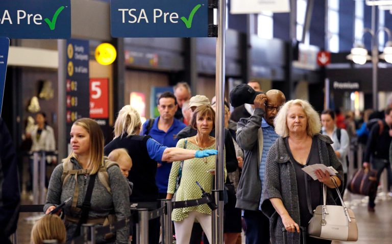 Passengers at a TSA pre-check line are directed to a different line to go through a security check-point at Seattle-Tacoma International Airport, in SeaTac, Wash. TSA said July set a record for passenger screenings.
		 (AP Photo/Elaine Thompson)
