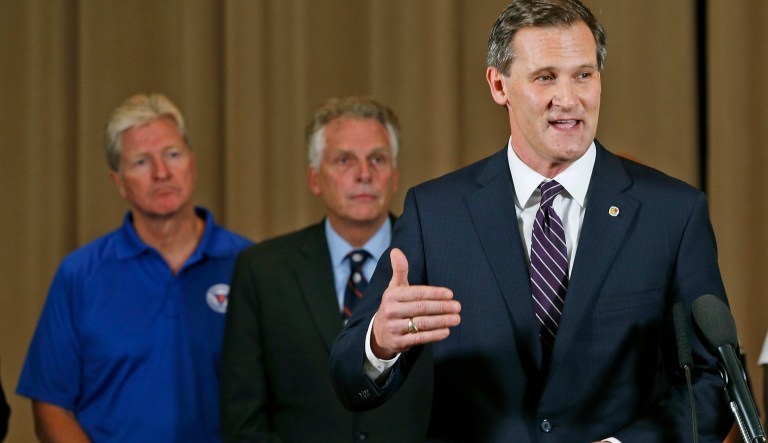 Charlottesville Mayor Mike Signer, right, gestures during a news conference concerning the white nationalist rally and violence as Virginia Gov. Terry McAuliffe, center, and Virginia Secretary of Public safety Brian Moran, left, listen in Charlottesville, Va., Saturday, Aug. 12, 2017. (AP Photo/Steve Helber)