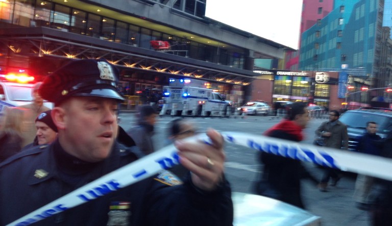 Police respond to a report of an explosion near Times Square on Monday in New York. Several reports said police had a suspect in custody who appeared to be wearing an explosive device. (AP Photo/Charles Zoeller)